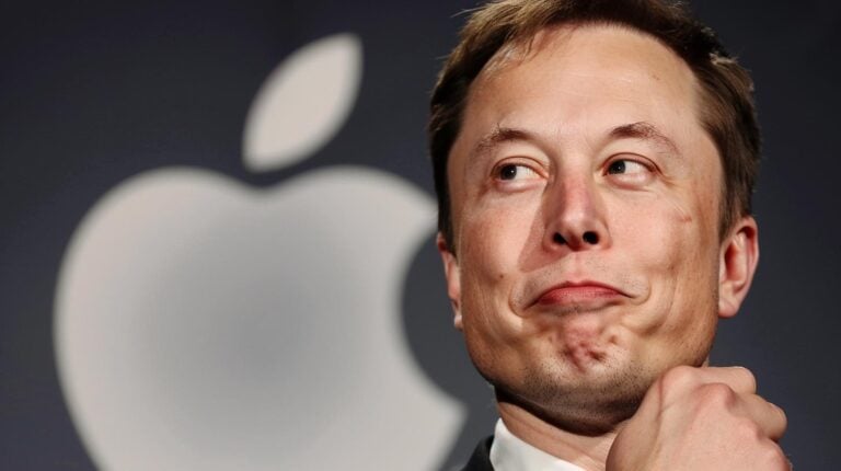 Businessman in front of Apple logo making a thoughtful expression